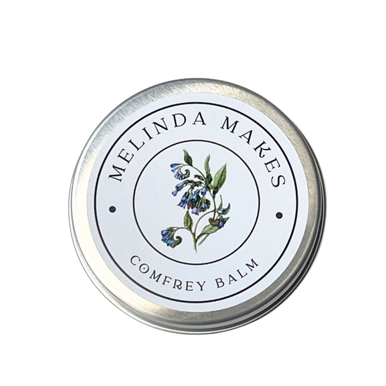 Tin of Melinda Makes Comfrey Balm with a comfrey flower