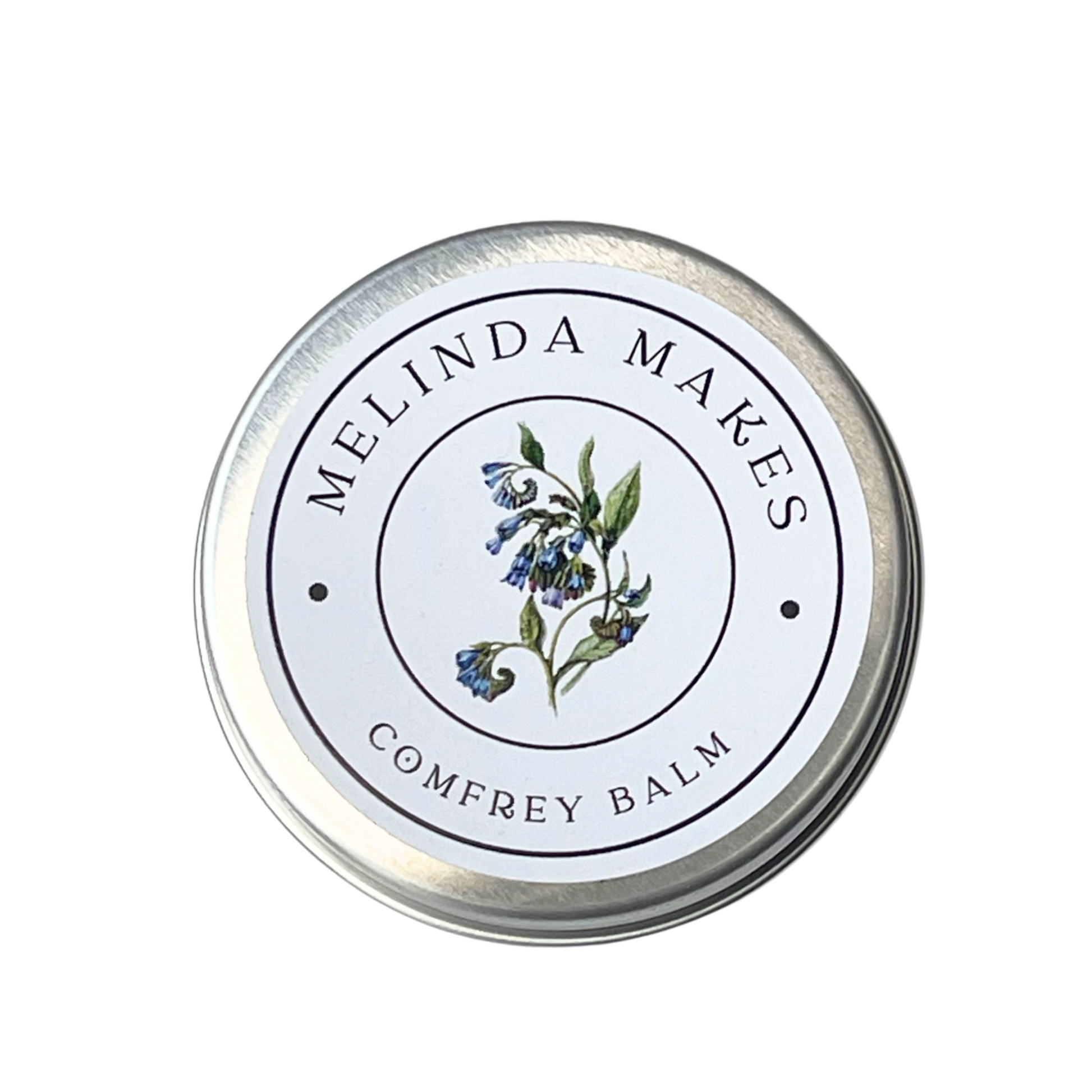 Tin of Melinda Makes Comfrey Balm with a comfrey flower