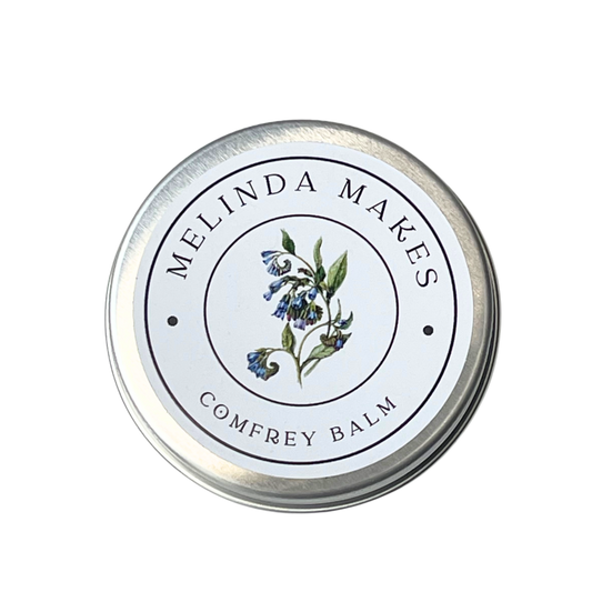 Tin of Melinda Makes Comfrey Balm with a comfrey flower