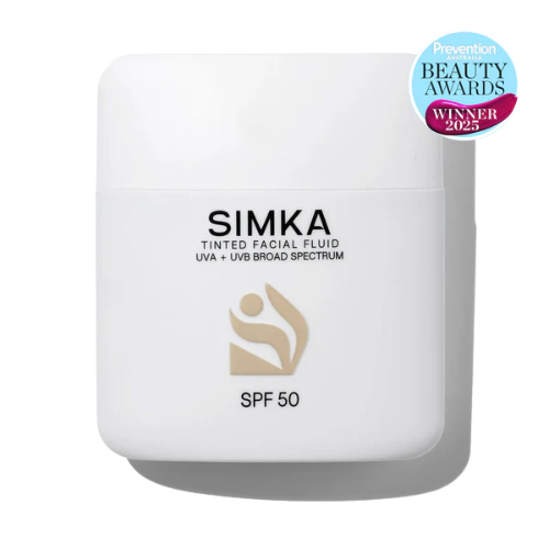 Simka tinted facial fluid with SPF 50 on a transparent background, featuring an award badge.