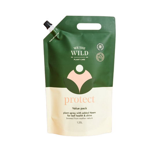 Green and beige plant care product packaging with 'We the Wild' branding on a white background.
