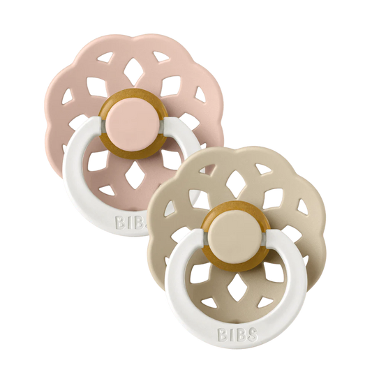 Set of two BIBS Boheme pacifiers featuring  blush and vanilla flower-style silicone shields, and white ring handles—premium baby soothers for newborns and infants. Glow in the dark, round, size one.
