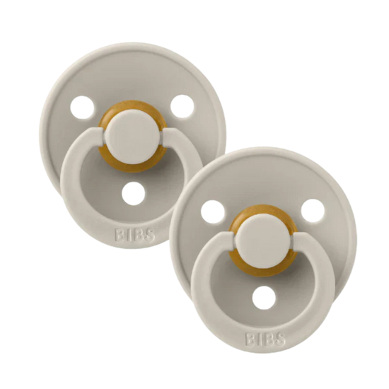 Two baby bibs dummies sand.