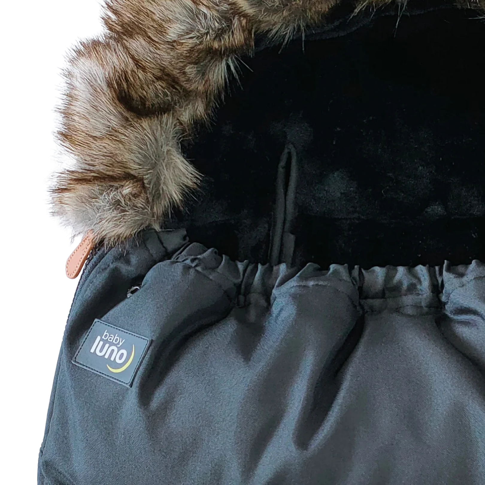 Close-up of a black baby footmuff pram liner with fur hood and 'baby luno' label 