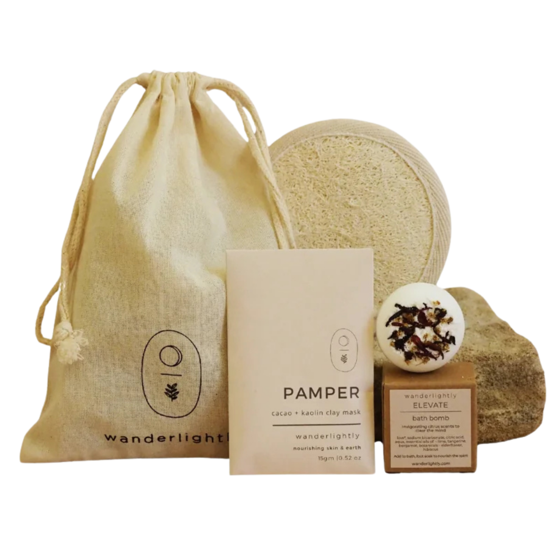 Collection of natural skincare products including a drawstring bag, soap, and bath bombs on a white background. Mini spa hamper 