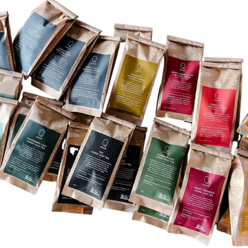 Assorted tea packages with visible brand logos on a white background