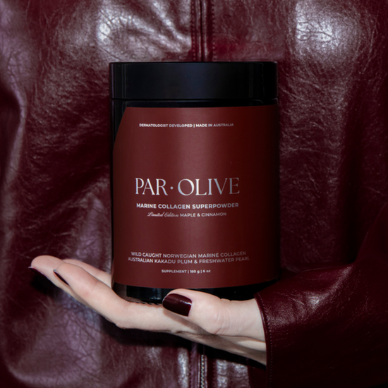 Jar of Par-Olive Marine Collagen Superpowder held by a hand against a textured brown background
