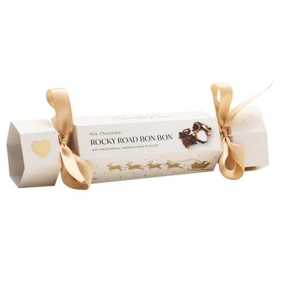 Roll of Rocky Road bonbons with decorative ribbon on a white background
