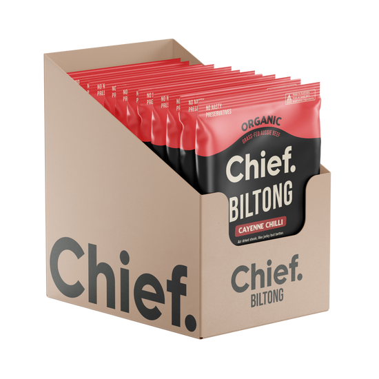 A cardboard display box filled with Chief Biltong cayenne chili biltong pouches, shown