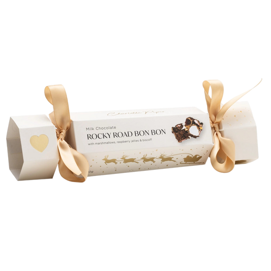 Roll of Rocky Road bonbons with decorative ribbon on a white background