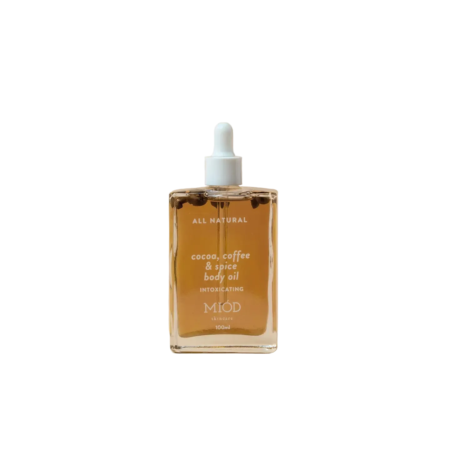 Bottle of Miod cocoa, coffee, & spice body oil on a beige background 100ml