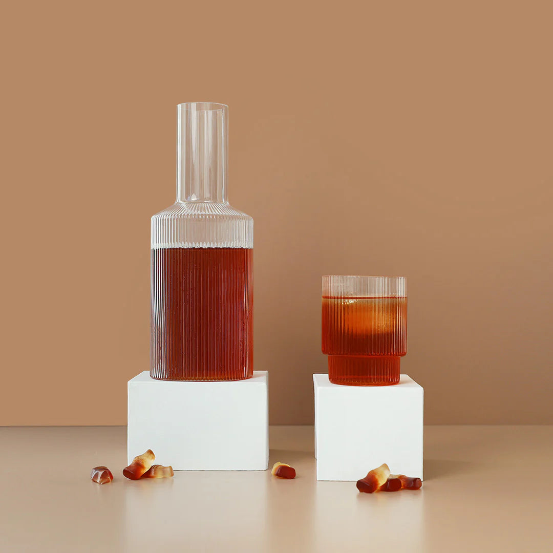 cola hydramama being poured into glass with cola bottle lollies sitting