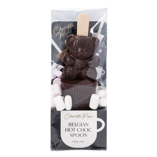 Dark chocolate bear with a hot chocolate spoon and marshmallows in packaging, featuring the brand 'Charlotte Piper'.