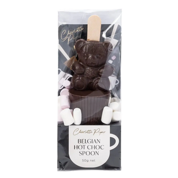 Dark chocolate bear with a hot chocolate spoon and marshmallows in packaging, featuring the brand 'Charlotte Piper'.