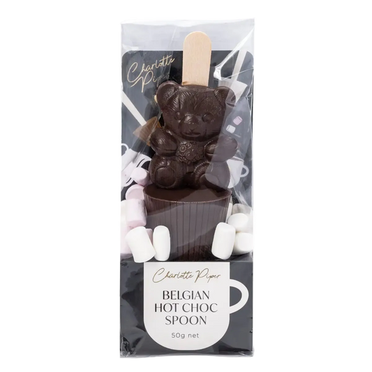 Dark chocolate bear with a hot chocolate spoon and marshmallows in packaging, featuring the brand 'Charlotte Piper'.
