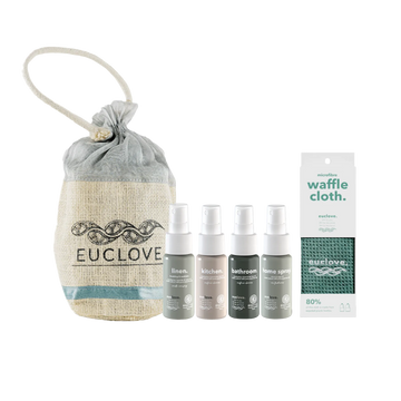 A home fragrance gift set from Euclove including a beige burlap drawstring pouch, four small spray bottles in linen, kitchen, bathroom, and home spray scents, and a white waffle cloth.