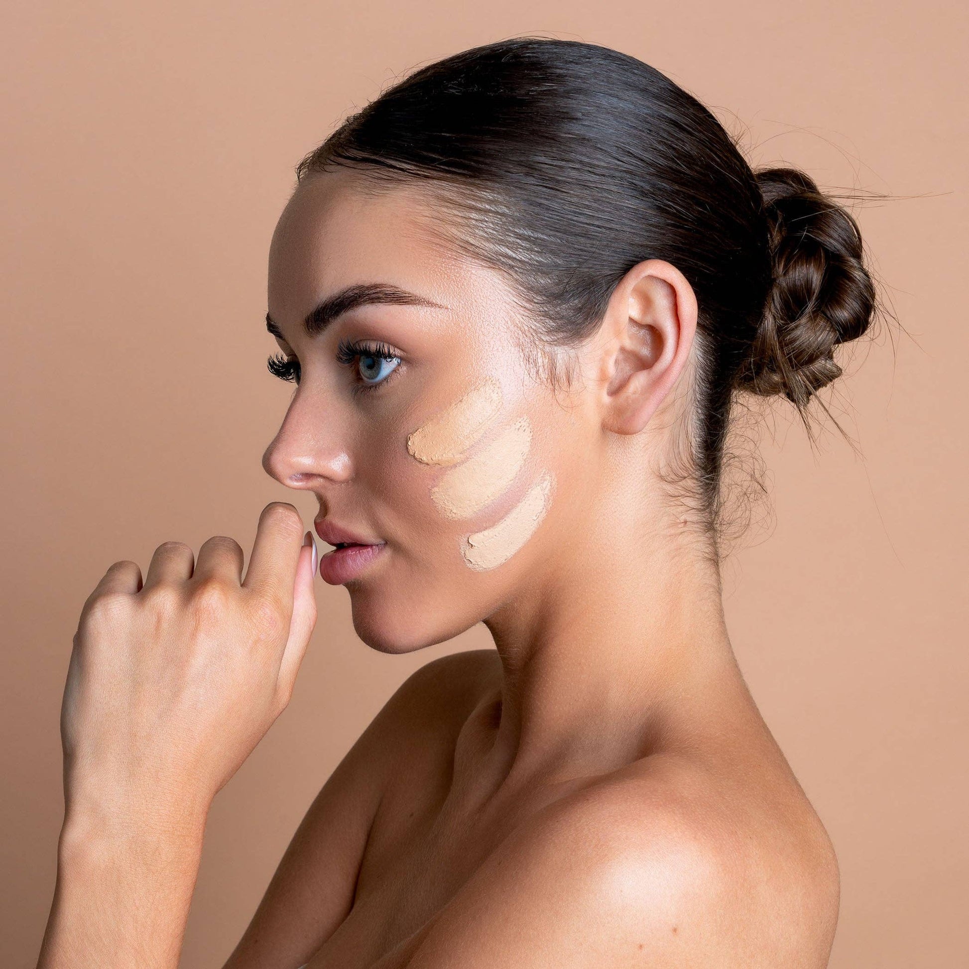 Woman applying makeup avo zinc swatches 