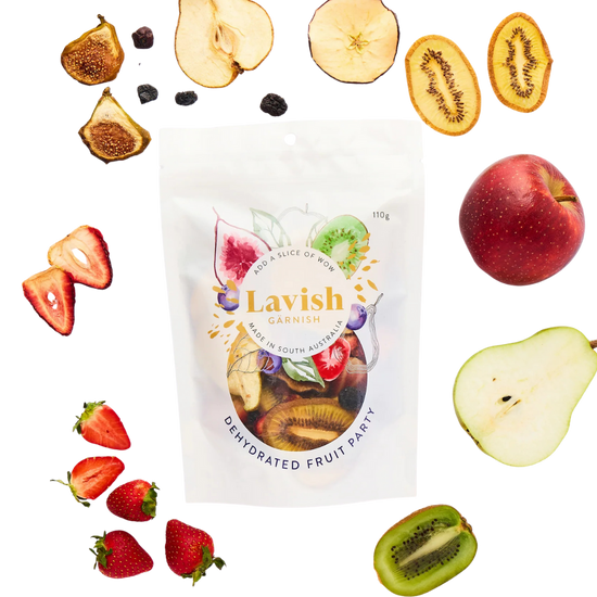 Lavish Garnish dehydrated fruit package with various fruits around it on a white background