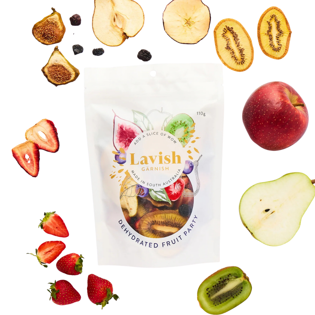 Lavish Garnish dehydrated fruit package with various fruits around it on a white background