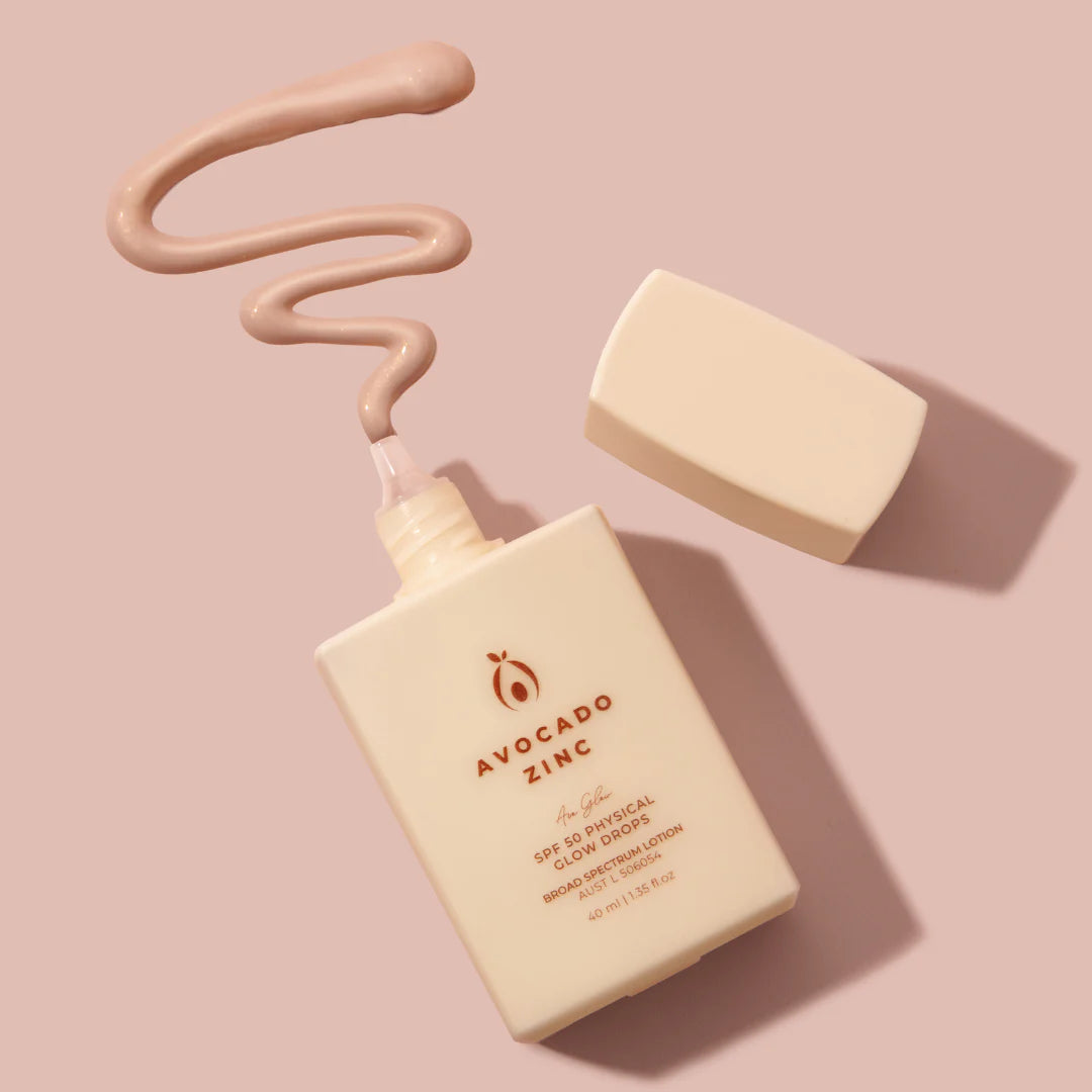 Avocado Zinc skincare glow drops product with a pump and applicator on a pink background