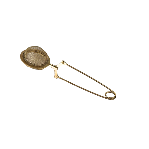 Gold-colored tea strainer on a white background