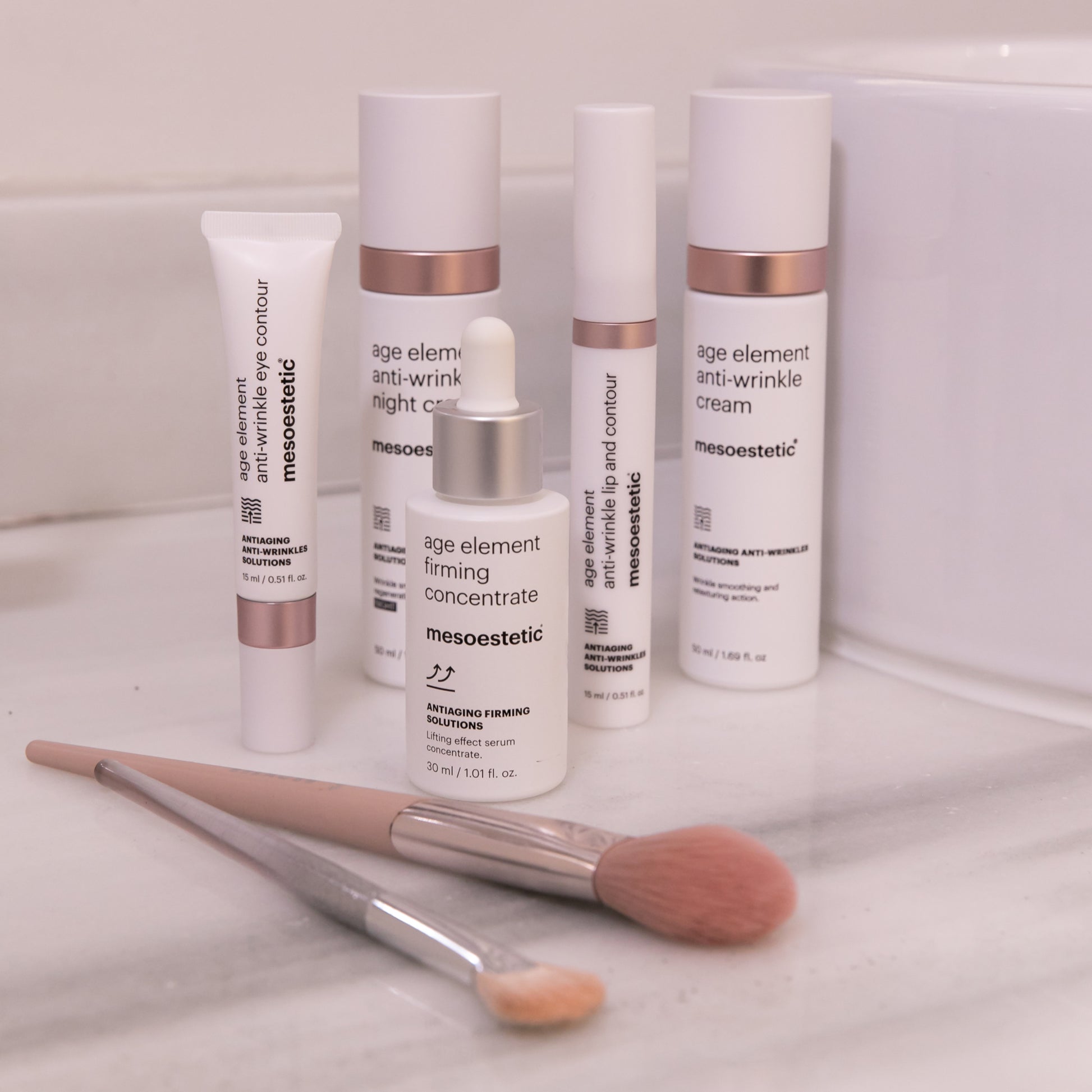Mesoestetic skincare products with applicators on a white surface