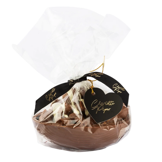 Chocolate egg in clear packaging with a black heart-shaped tag saying charlotte piper