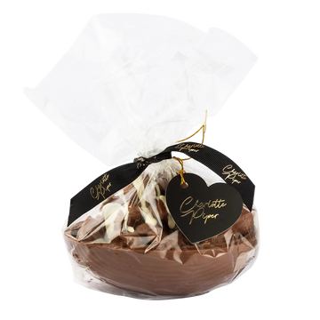Chocolate egg in clear packaging with a black heart-shaped tag saying charlotte piper