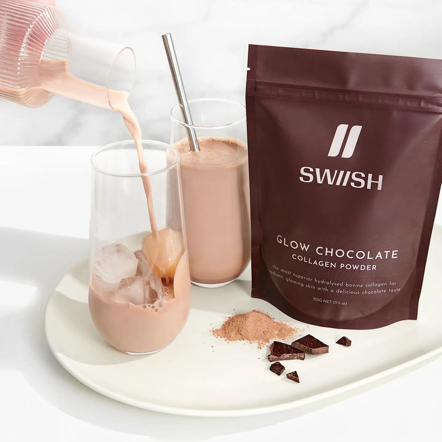 Swish Glow Chocolate Collagen Powder being poured into a glass with a white background