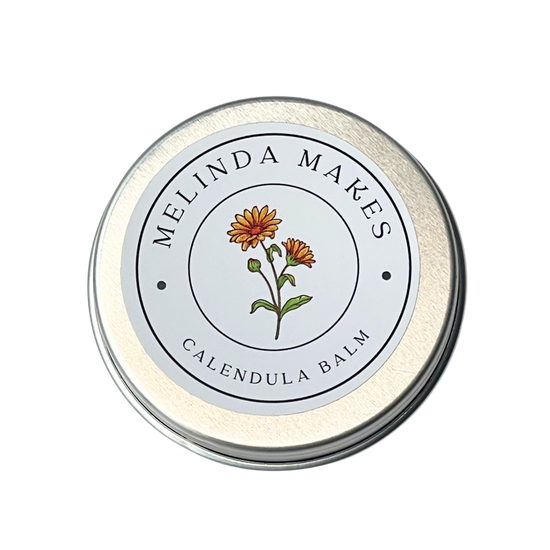 Tin of Melinda Makes Calendula Balm with calendula floral on it