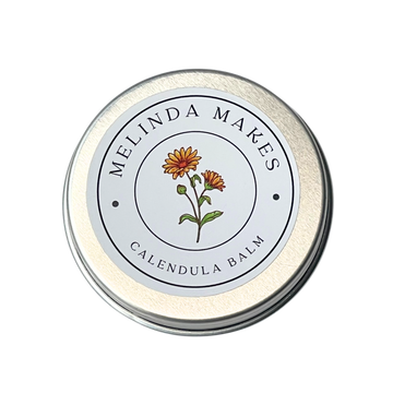 Tin of Melinda Makes Calendula Balm with calendula floral on it