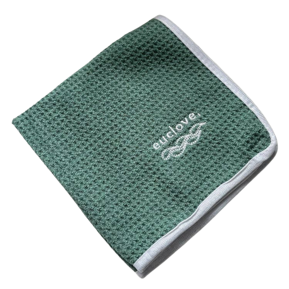 A folded green waffle-weave cleaning cloth with a white embroidered 'enclove' logo and a white ribbed border.