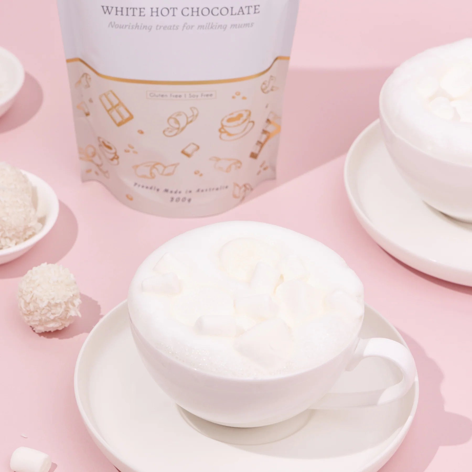 Lactation White hot chocolate with a container labeled 'White Hot Chocolate' on a pink background